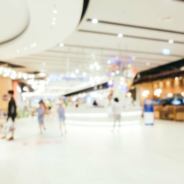 Abstract blur and bokeh defocused shopping mall interior of department store for background